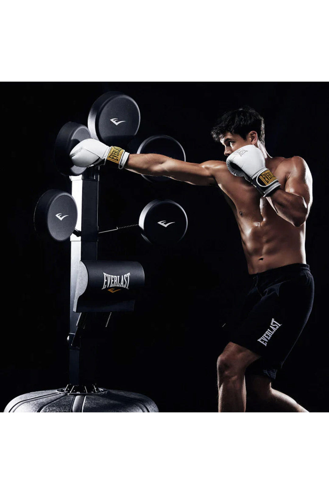 man in white boxing gloves striking focus pad