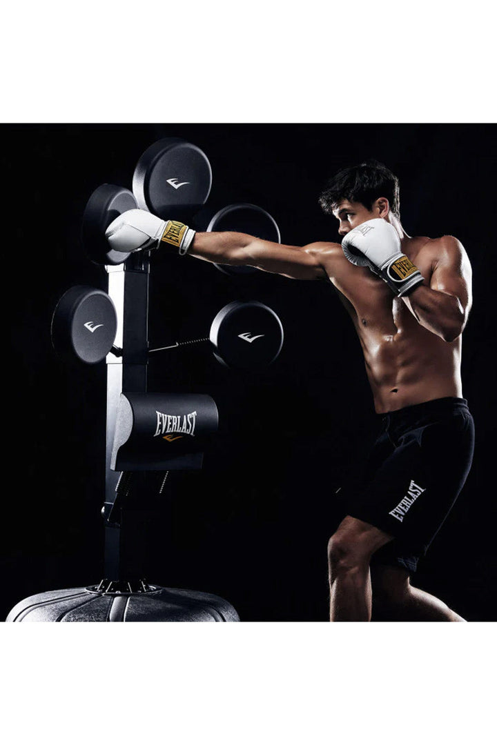 man in white boxing gloves striking focus pad
