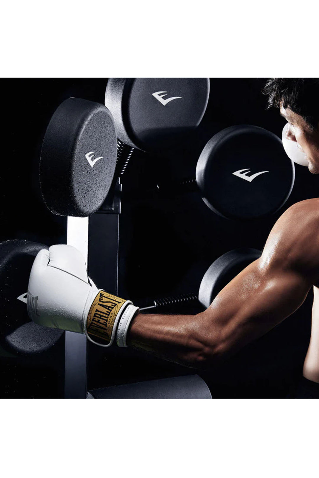 Man in white boxing gloves jabbing a boxing tree