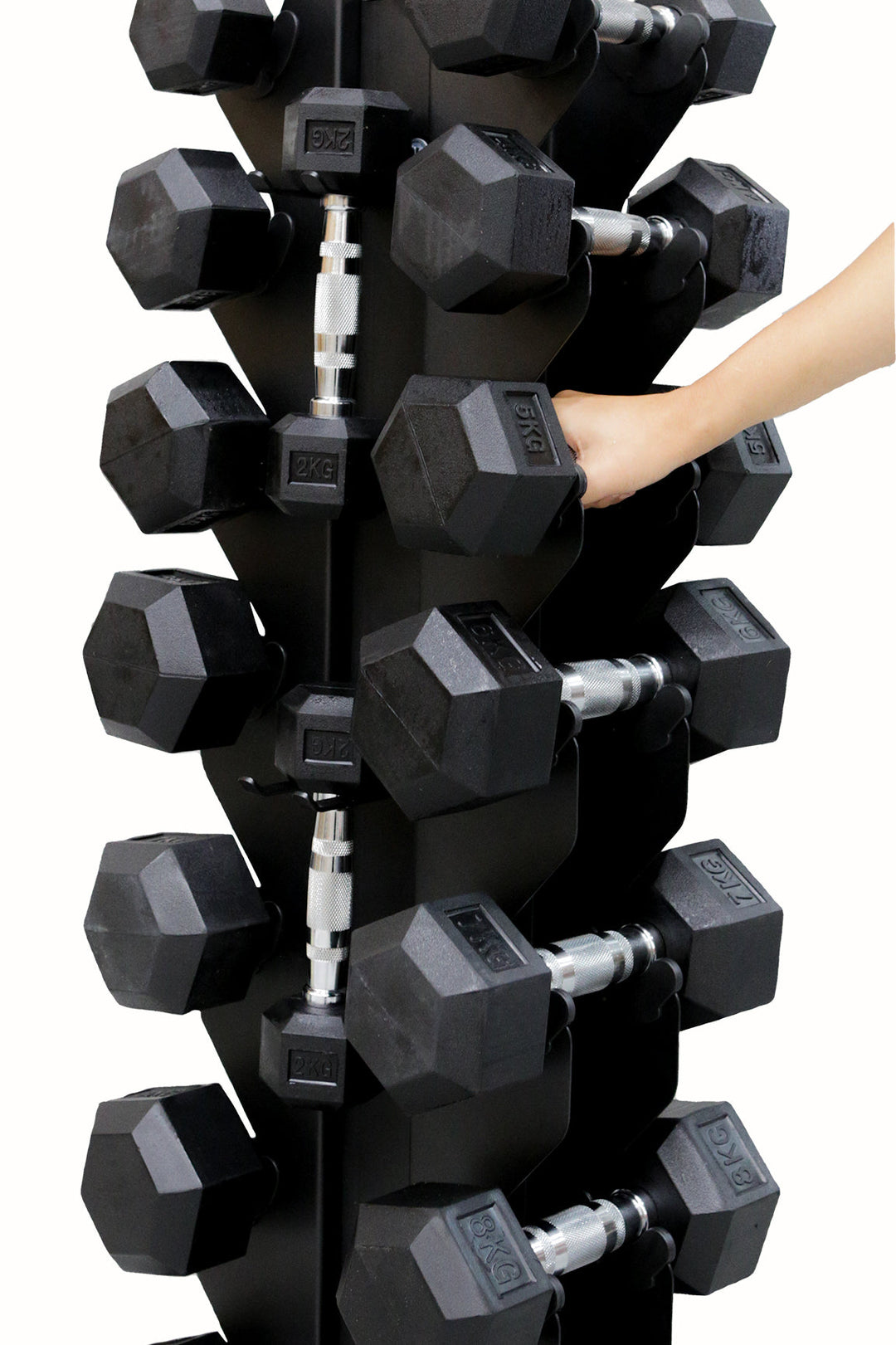 Woman placing dumbbell back onto hex dumbbell rack
